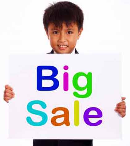 A child holding big sale giveaway placard