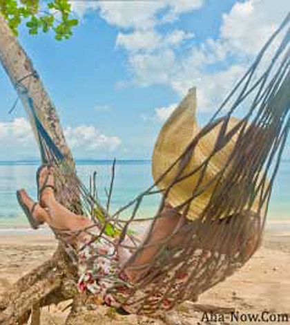A woman on a hammock by the beach sending a message you can make your life easier if you take it easy