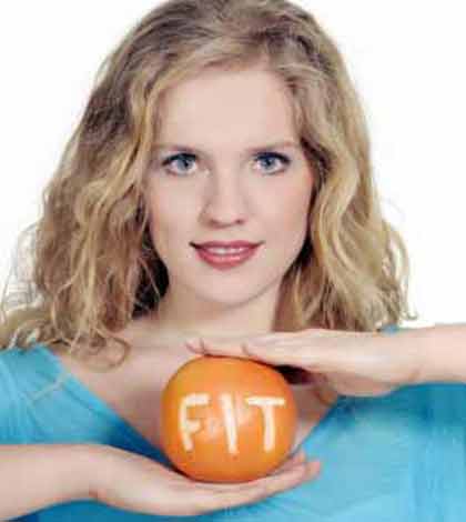a girl holding an orange showing a healthy lifestyle option