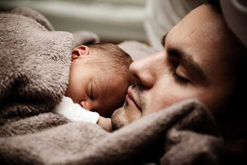man playing role of the father by taking care of baby