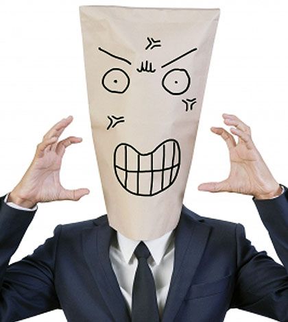 Man wearing a paper mask of anger