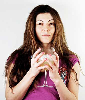 a woman drinking alcohol which is one of the ways to reduce stress