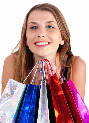 Woman holding bags after shopping spree as ways to reduce stress