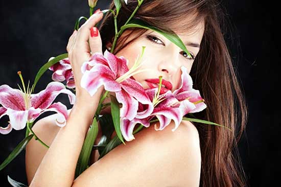 woman smelling flowers to relieve stress