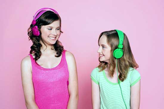 Two teens with headphones listening music for stress relief