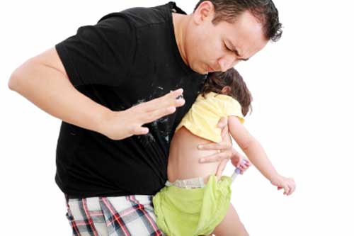 Father using spanking to discipline kid