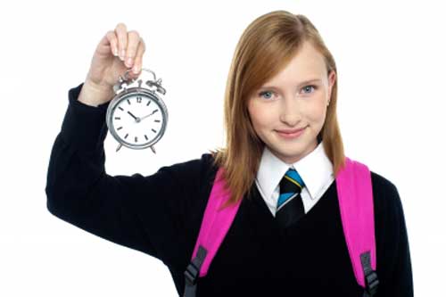Girl with clock in hand telling importance of time
