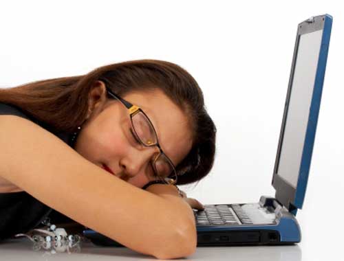 Girl sleeping on laptop after excessive use of social media