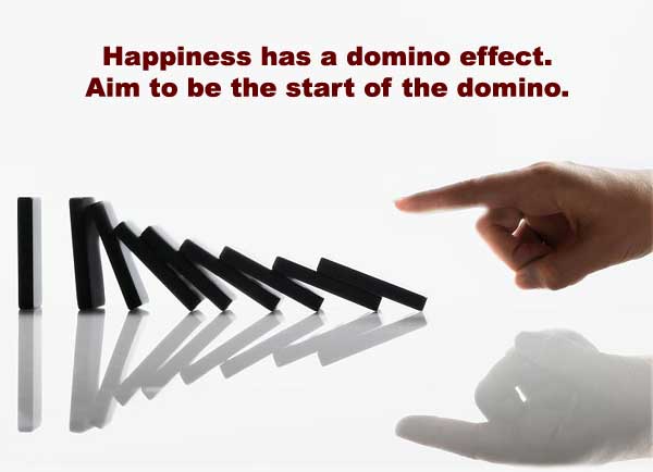 Man pushing the first domino to create the domino effect.