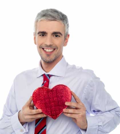 A man holding a heart toy in hand