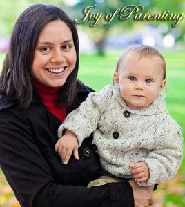 Mother holding baby in arms using effective parenting tips.