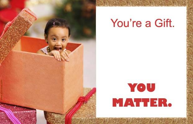 A baby inside a gift box and a quote that you matter.