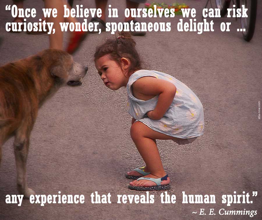 Little girl with self belief curiously watching a dog