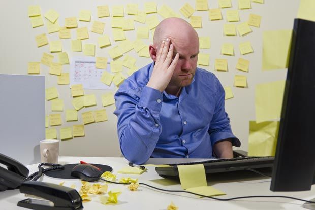 Man upset by too many post-it notes in home office