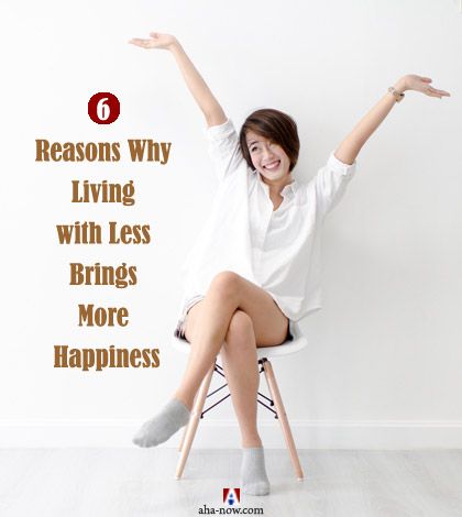 A women happy with her minimalist living sitting on a chair living with less.