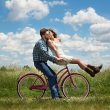 Man riding cycle with woman sitting on the front