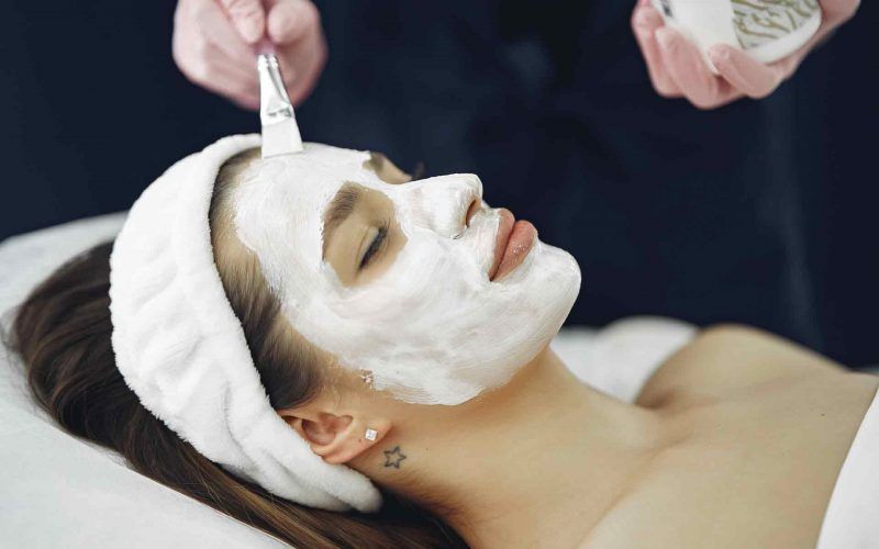 Woman getting face mask on her face to treat her skin better
