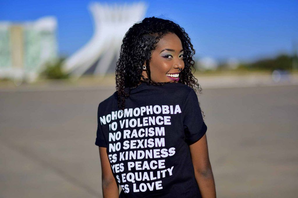 Black woman wearing black custom printed t-shirt with slogans