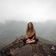 Woman on top of mountain in meditation as mindful practice