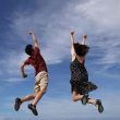 Boy and girl jumping in air enjoying small happy moments