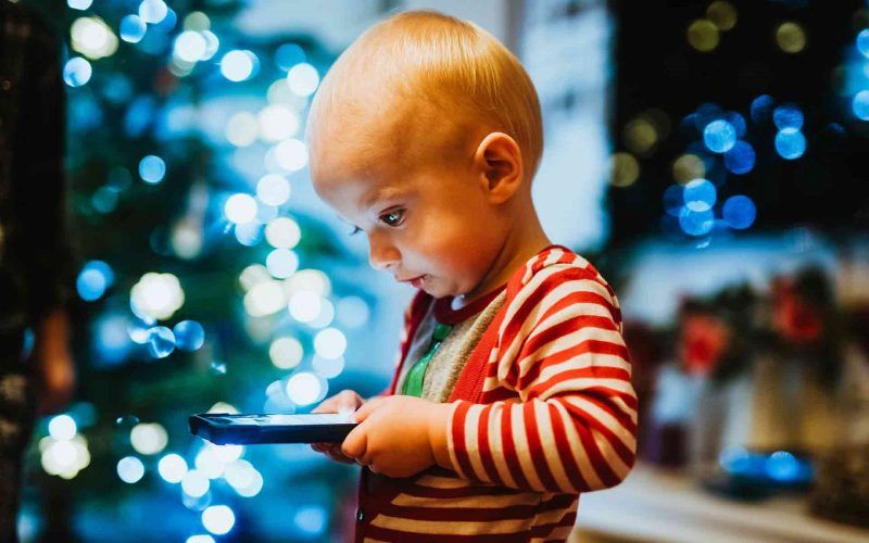 Kid having screen time with mobile in hand