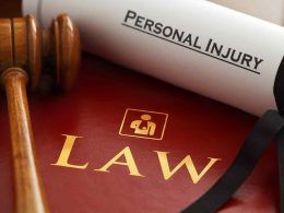 personal injury document upon a law book and hammer