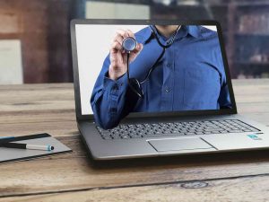 Doctor in a laptop giving telemedicine services