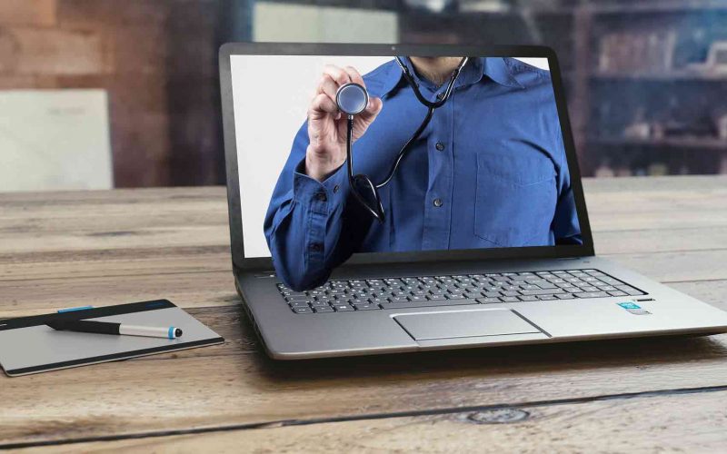 Doctor in a laptop giving telemedicine services