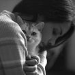 A girl hugging a cat to combat anxiety