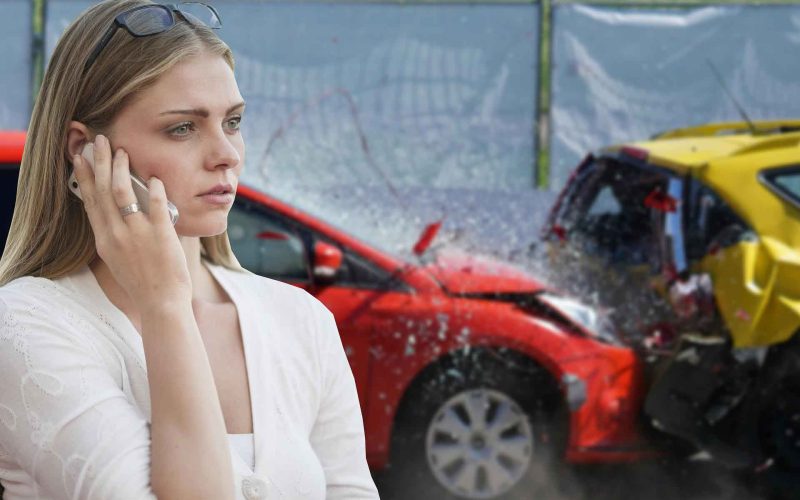 Woman calling on mobile after a car accident