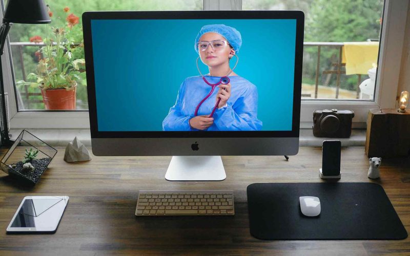 Doctor on desktop video call offering telehealth services