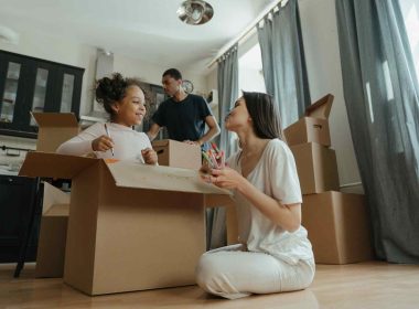 family with kids preparing boxes for long-distance moving
