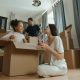 family with kids preparing boxes for long-distance moving